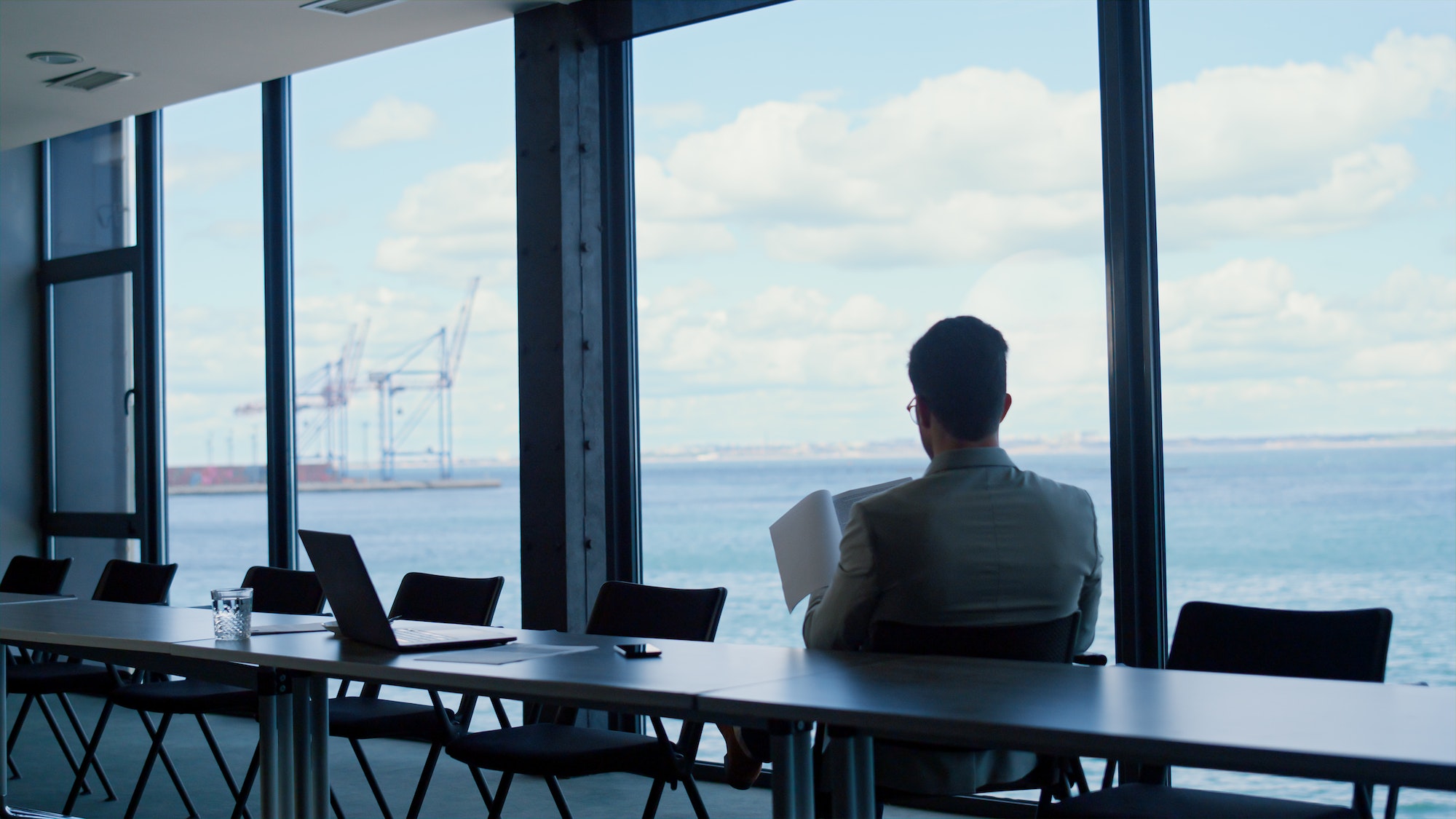 Leader person reading papers at panorama window view. Analyzing deal concept